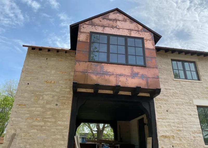 Copper metal panel facade on a stone building for Skylight Installation in Fitzgerald